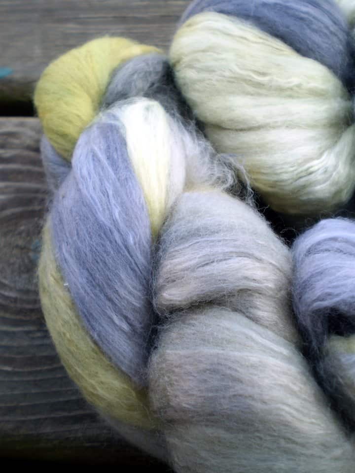 Alpaca Yarn in blues and lime green. Alpaca is a super warm fiber perfect for knitting sweaters.