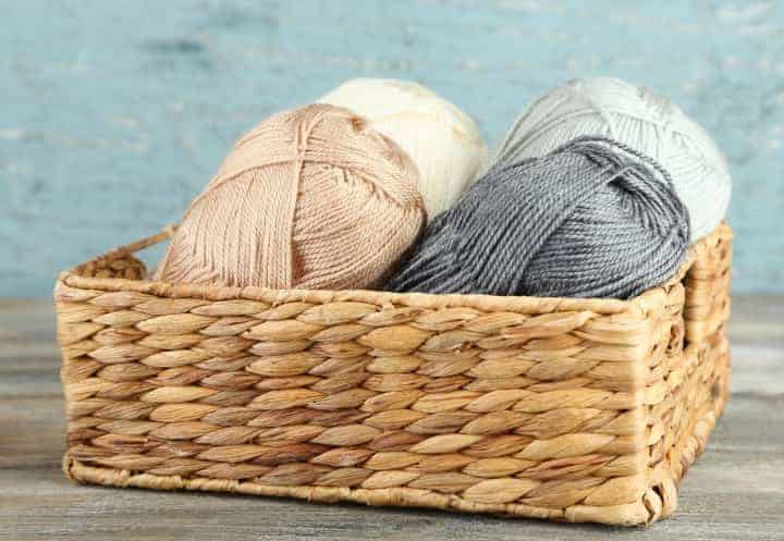 Organic Yarn stored in a raffia box of different greys and creams. Organic Yarn is not chemically treated.