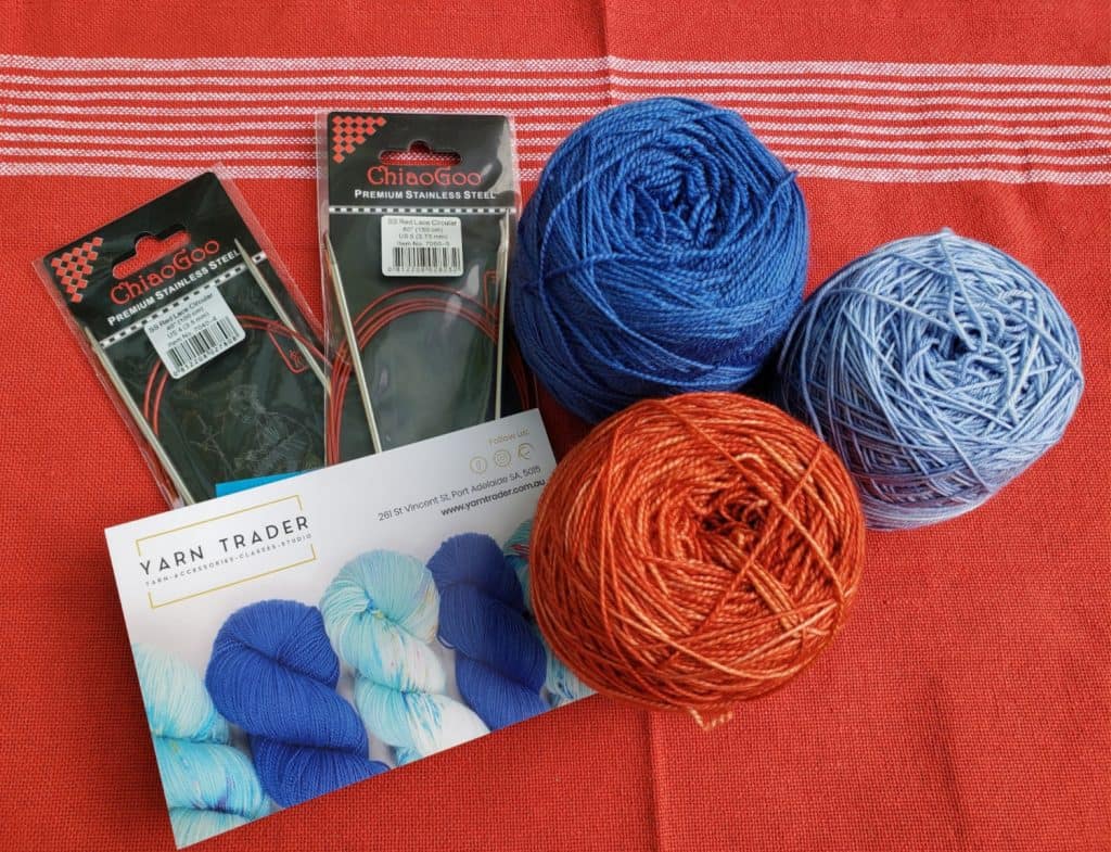 Merino Yarn from Yarn Trader in Electric Blue, Light Blue and Orange/Red, Chiaogoo Red Lace Circular needles
