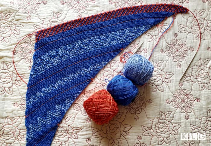 Extra Long Knitting Needles - Circular Needle with Stainless steel tips and red cable with my knitted Slip Love Knit shawl in blues and red yarns in progress.
