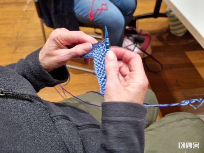 Jane knitting garter stitch squares at the Yarnistas monthly catchup