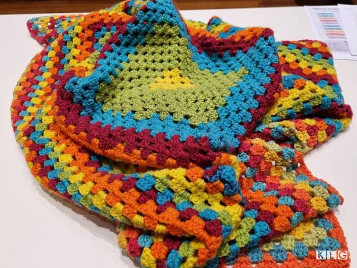 Granny Square blanket with green, blues, orange and yellow by Sarah