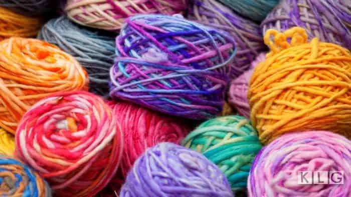 Yarn Cakes in many different colors, reds orange, purples, green, grey, blue, purple. Created with a Yarn Winder