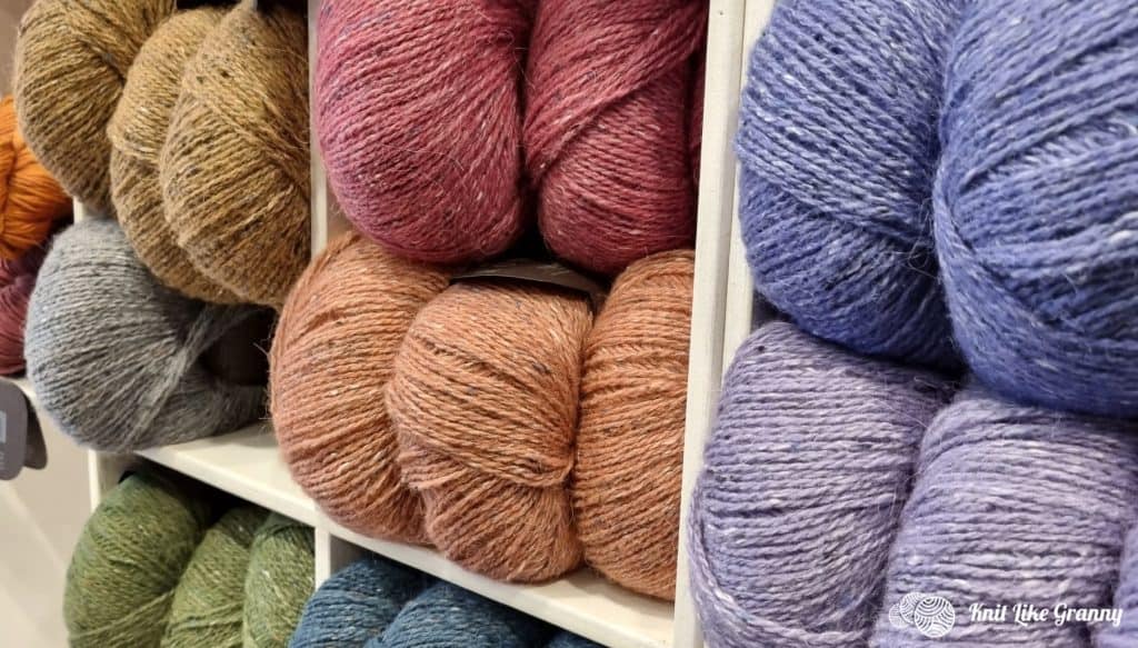 An Image Of A Closeup Of Big Skeins Of Colorful Heathered Yarn