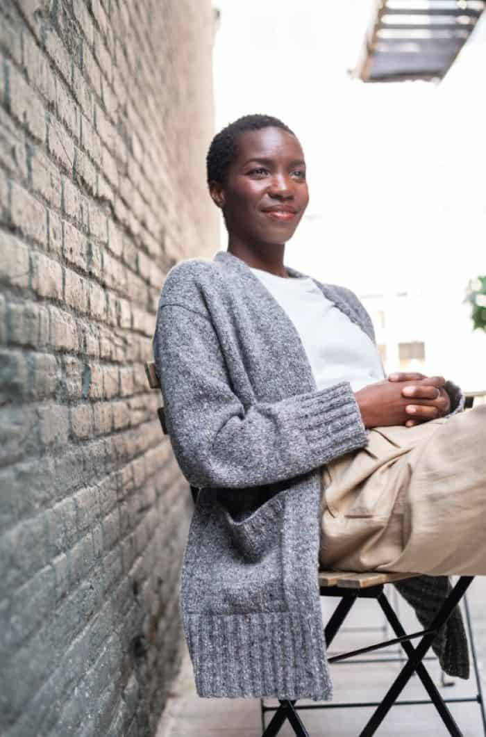 Dern Cardigan knit in gray tweed yarn. Long length with wide ribbed cuffs on sleeves and hem. Two large pockets on each front panel. 